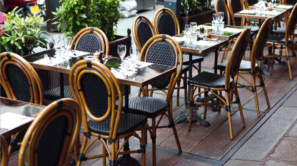 black and white rattan seats and tables on French patio